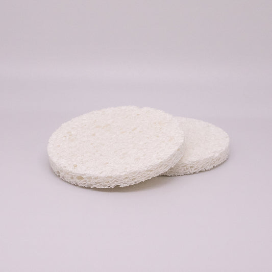 Two white circular pads on a light gray background
