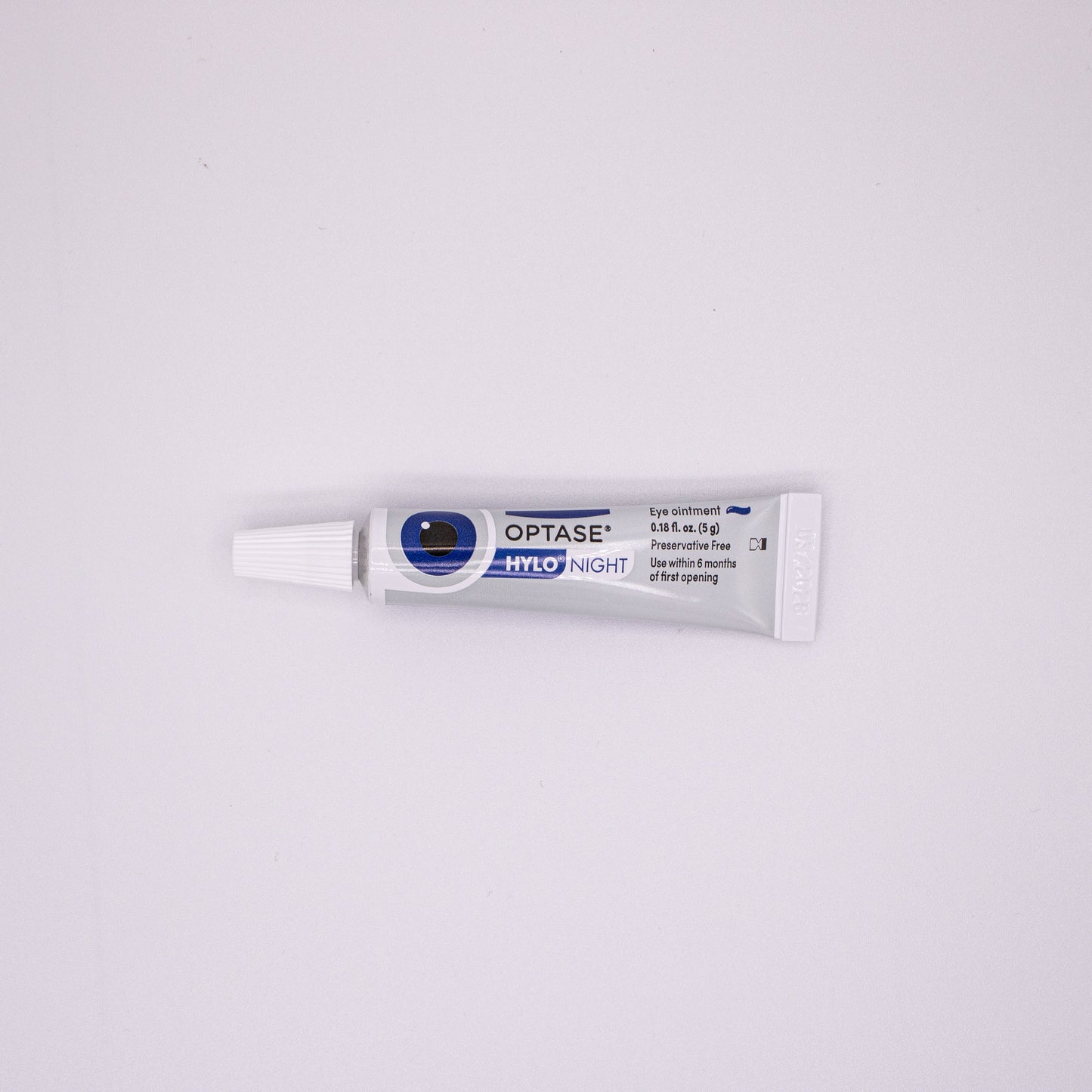 Optase eye drop tube on a white background