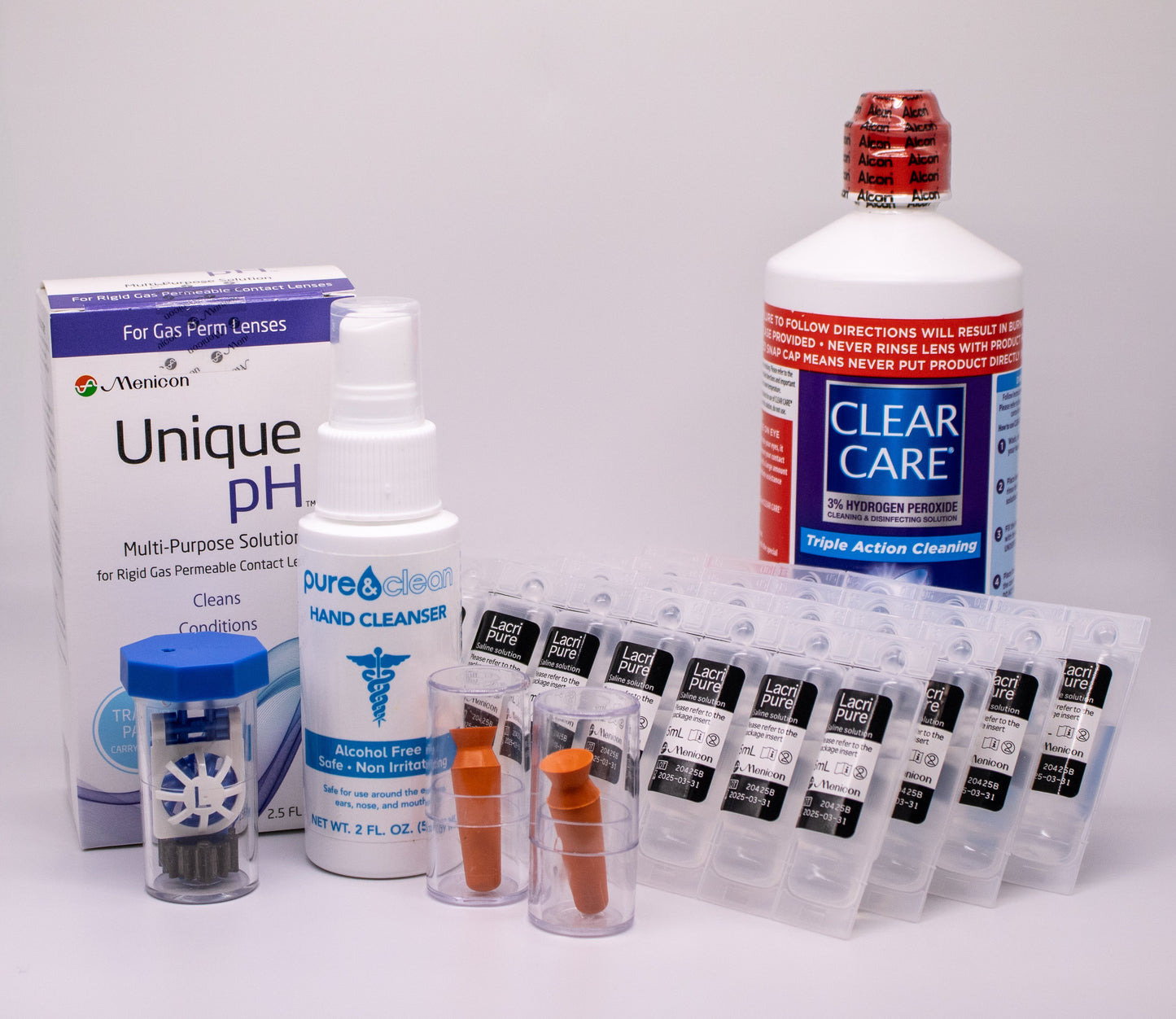 Collection of eye care products including a box labeled 'Unique pH', a bottle of 'Clear Care', and other related items on a white background.