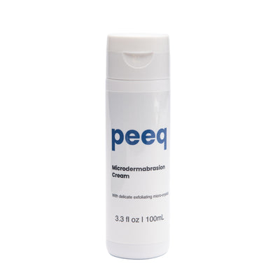 A bottle of Peeq Microdermabrasion Cream with white and blue labeling, indicating the brand and product details.