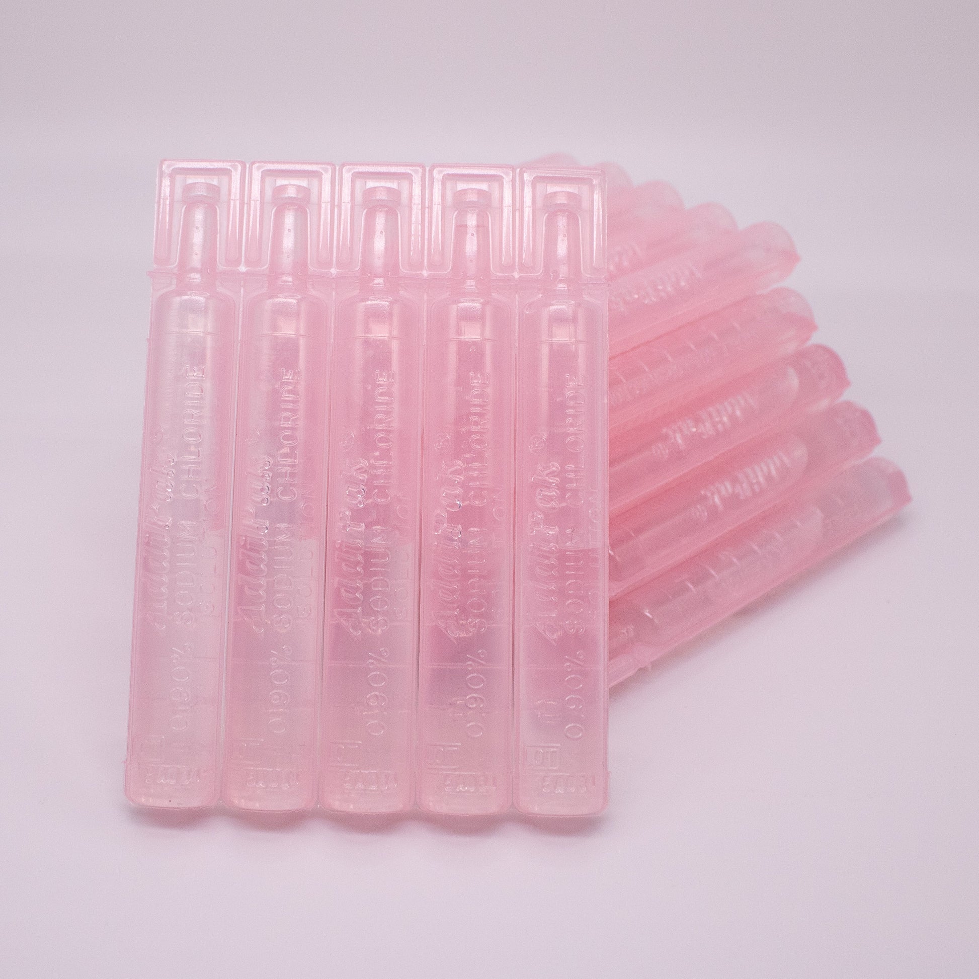 Stack of pink plastic straws on a light gray background