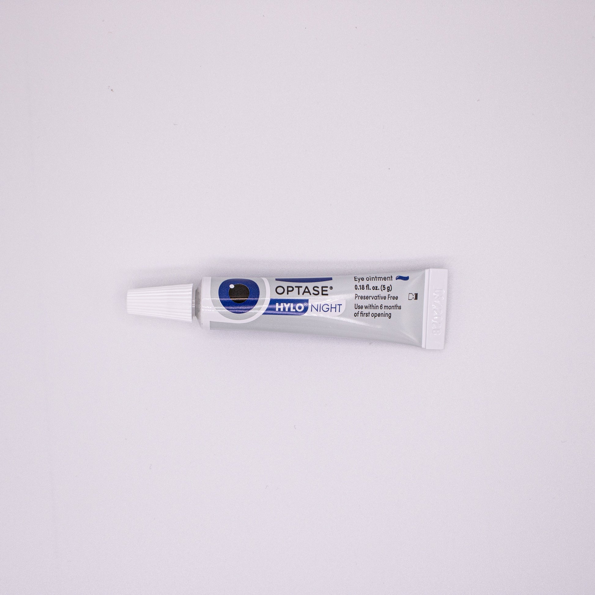 Optase eye drop tube on a white background