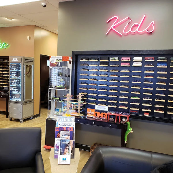 Store interior with 'Men' and 'Kids' signs, display cases, and seating area.